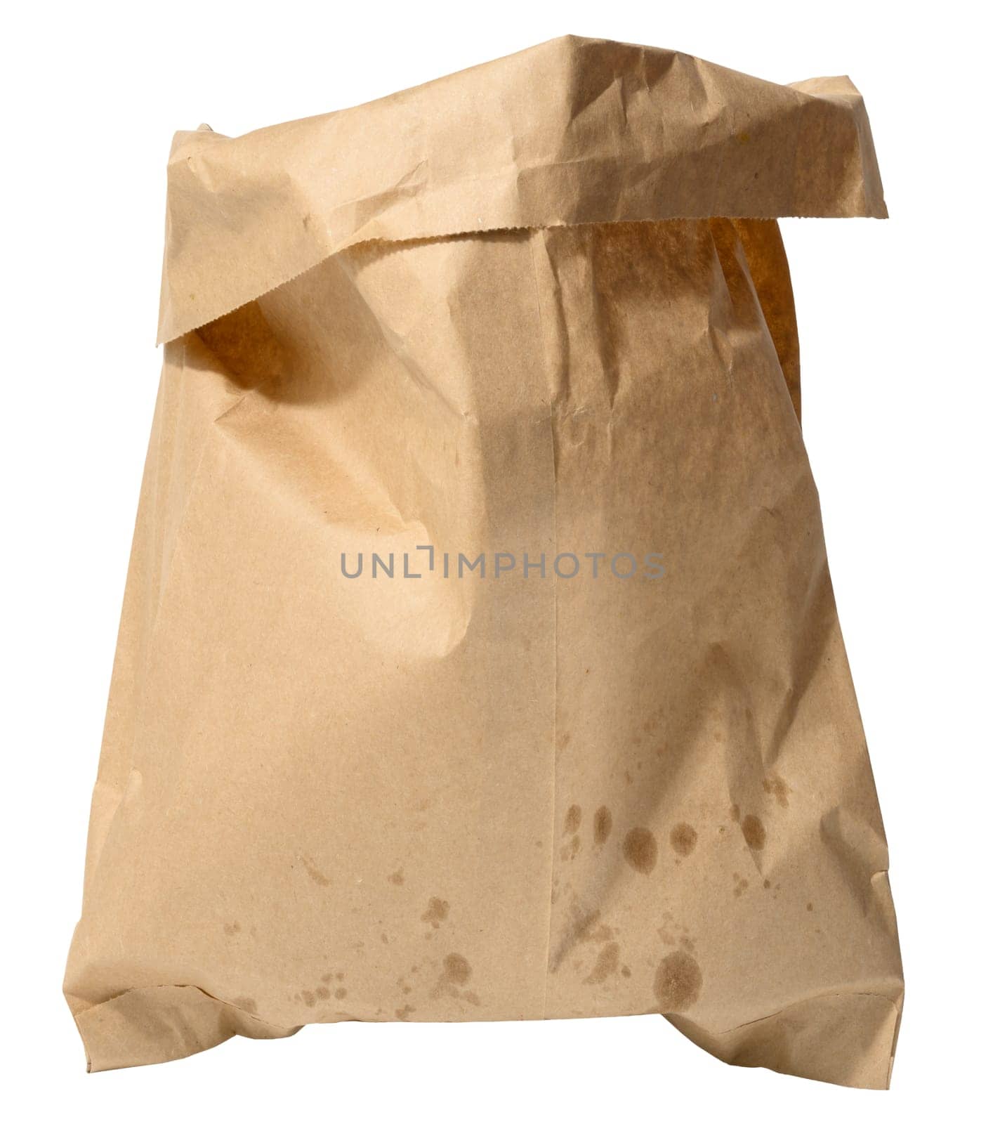 Crumpled brown paper bag with visible grease stains, standing upright on isolated background. Used for takeaway food or groceries