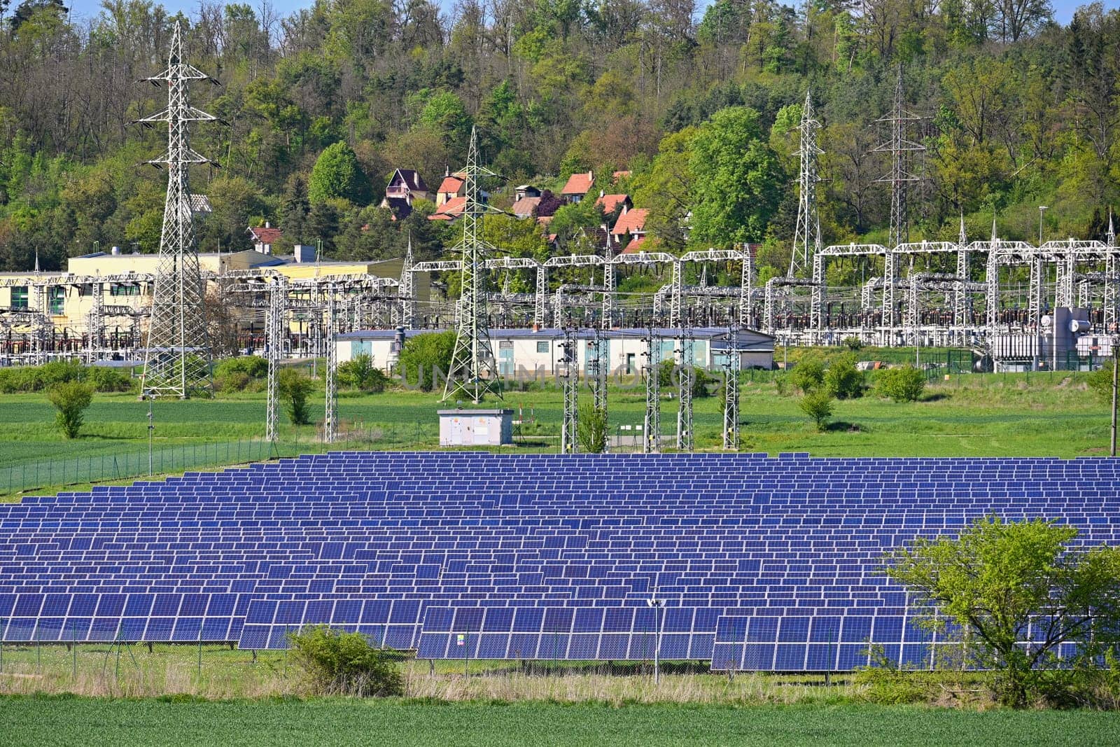 Electric power poles. Power plant - current distribution station. Concept for industry and technology with electricity.
Solar power plant -  ecological industry. Photovoltaic power plant.