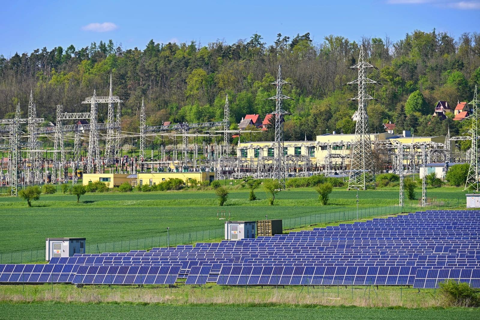 Electric power poles. Power plant - current distribution station. Concept for industry and technology with electricity.
Solar power plant -  ecological industry. Photovoltaic power plant.