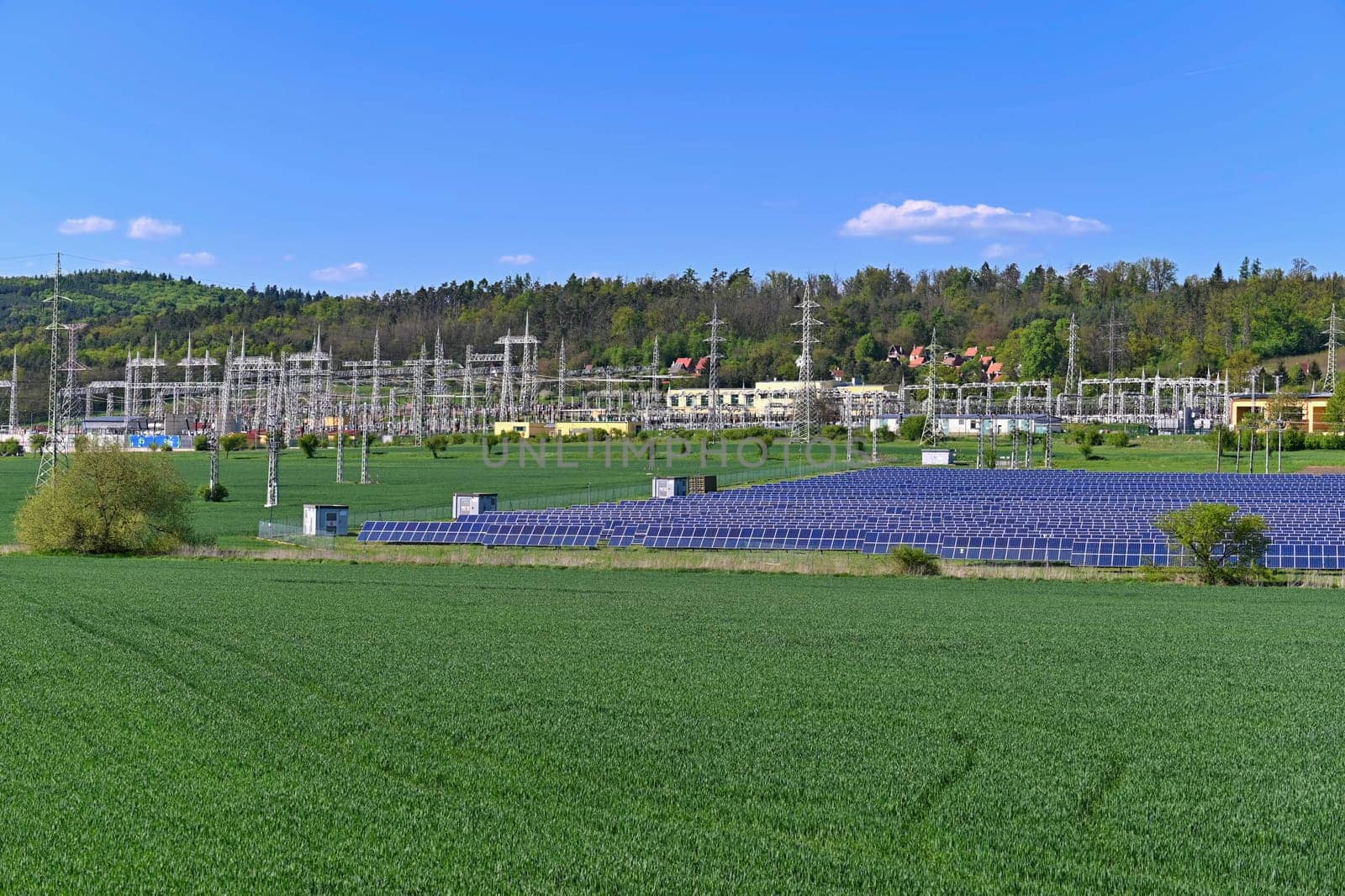 Electric power poles. Power plant - current distribution station. Concept for industry and technology with electricity.
Solar power plant -  ecological industry. Photovoltaic power plant.