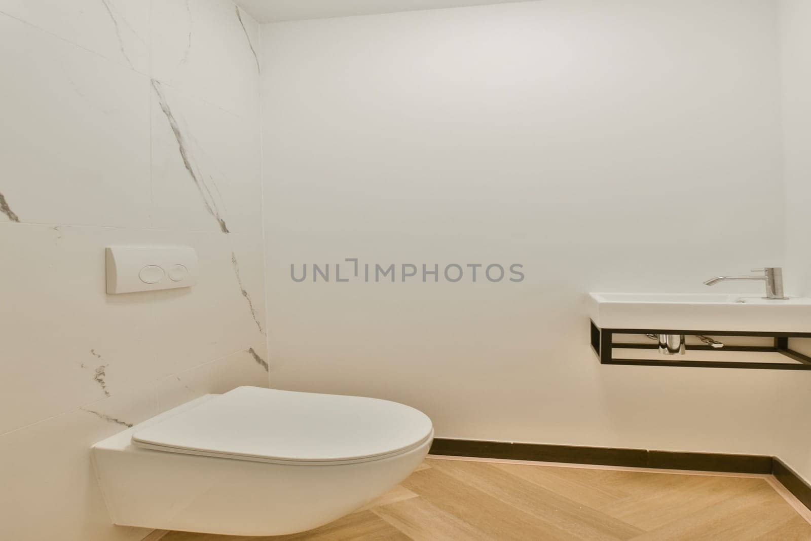 A sleek, modern bathroom featuring clean lines, a minimalist toilet, and a stylish sink. The neutral colors and elegant design create a serene atmosphere.