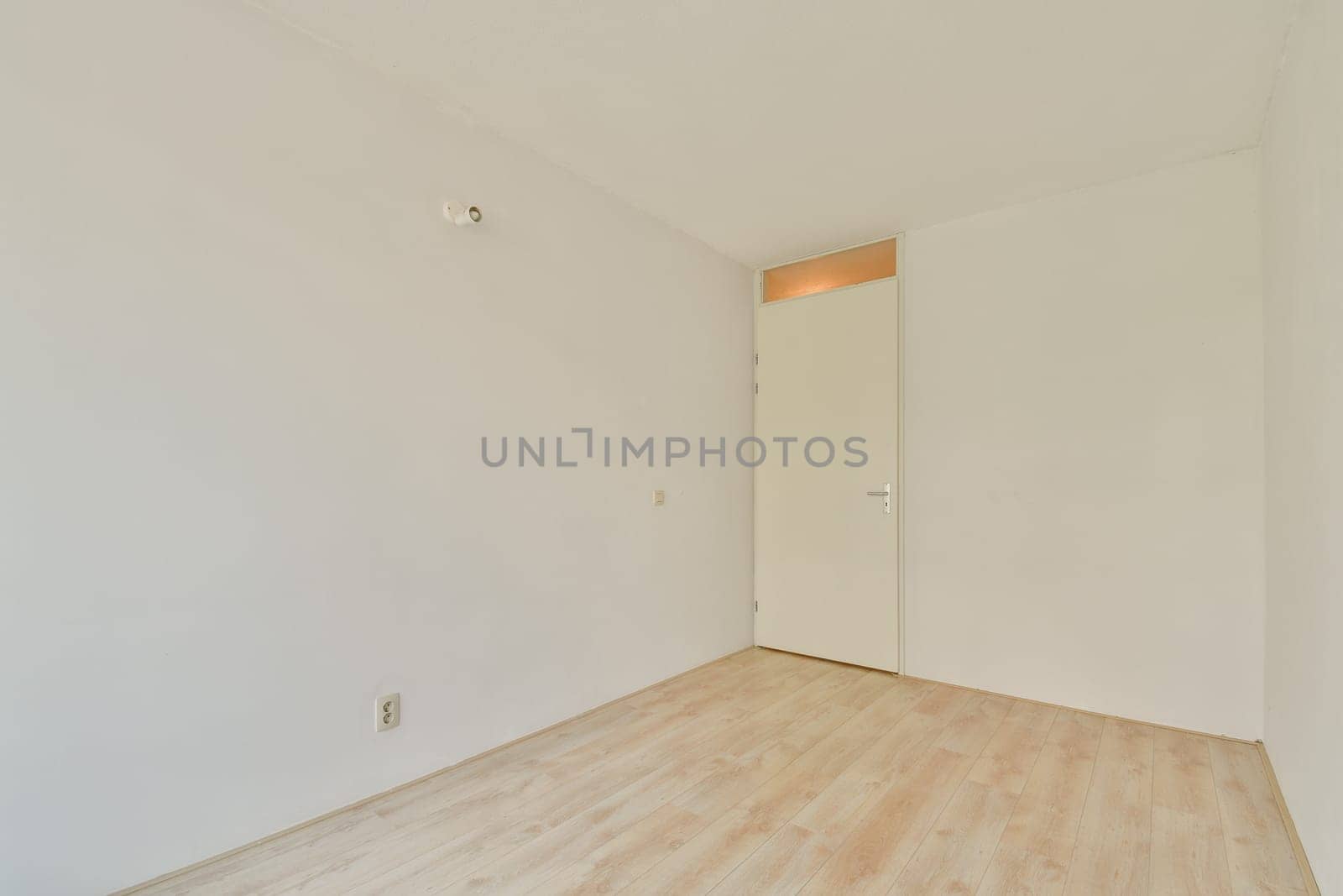 A spacious, minimalist interior featuring bare walls and wooden flooring, creating a serene and inviting atmosphere for various uses.