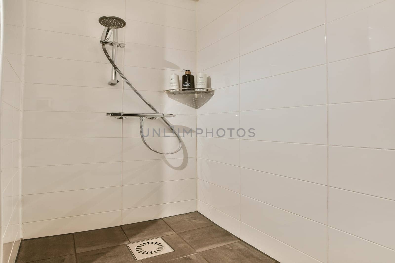 Sleek and contemporary shower setup showcased in a minimalist bathroom, emphasizing clean lines and efficient use of space for a relaxing experience.