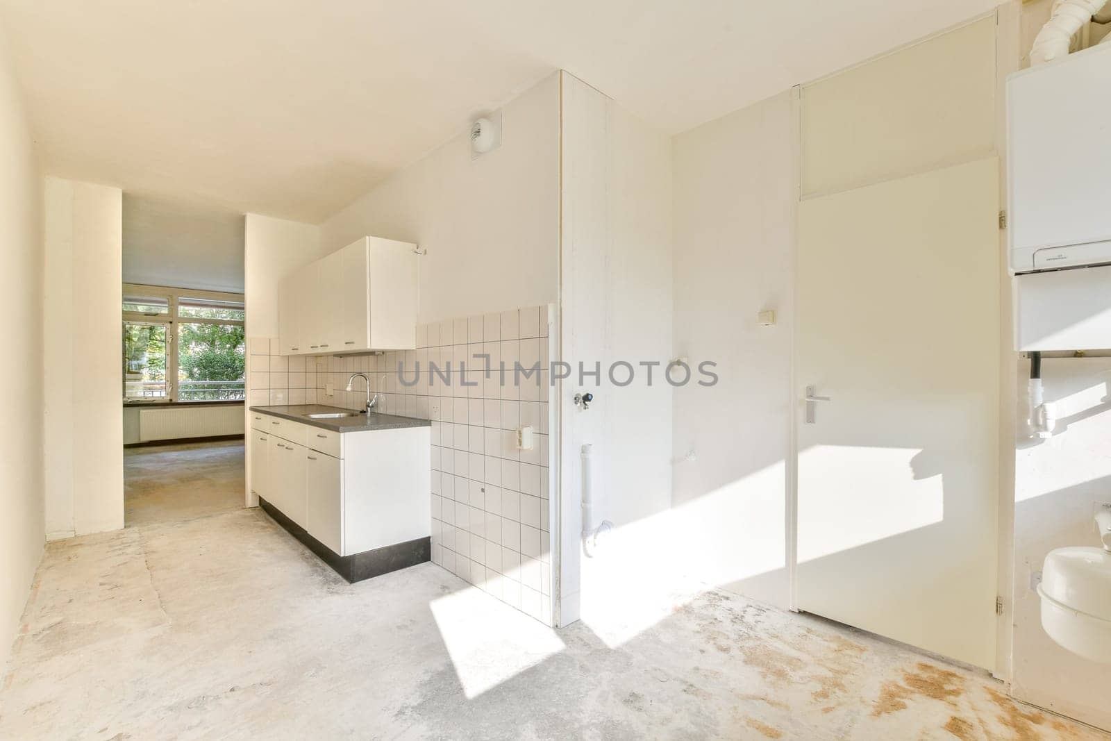 A bright and airy modern kitchen featuring minimalistic design elements, sleek cabinetry, and ample natural light from large windows.