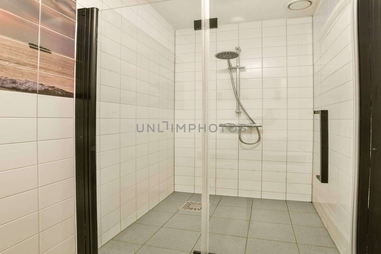 A sleek and modern shower stall featuring tiled walls and a minimalist design, creating a refreshing bathing space that combines functionality and style.