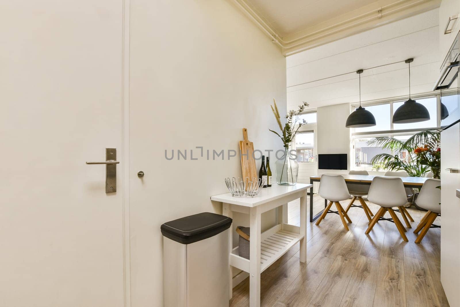 A bright and airy kitchen interior showcasing modern design elements with wood accents and sleek furniture, providing a contemporary and inviting atmosphere.