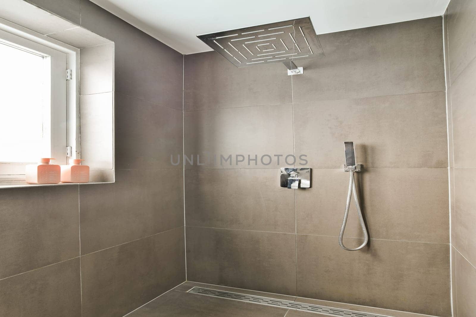 A sleek and modern bathroom shower featuring elegant tiles, a contemporary showerhead, and minimalist design elements for a stylish look.