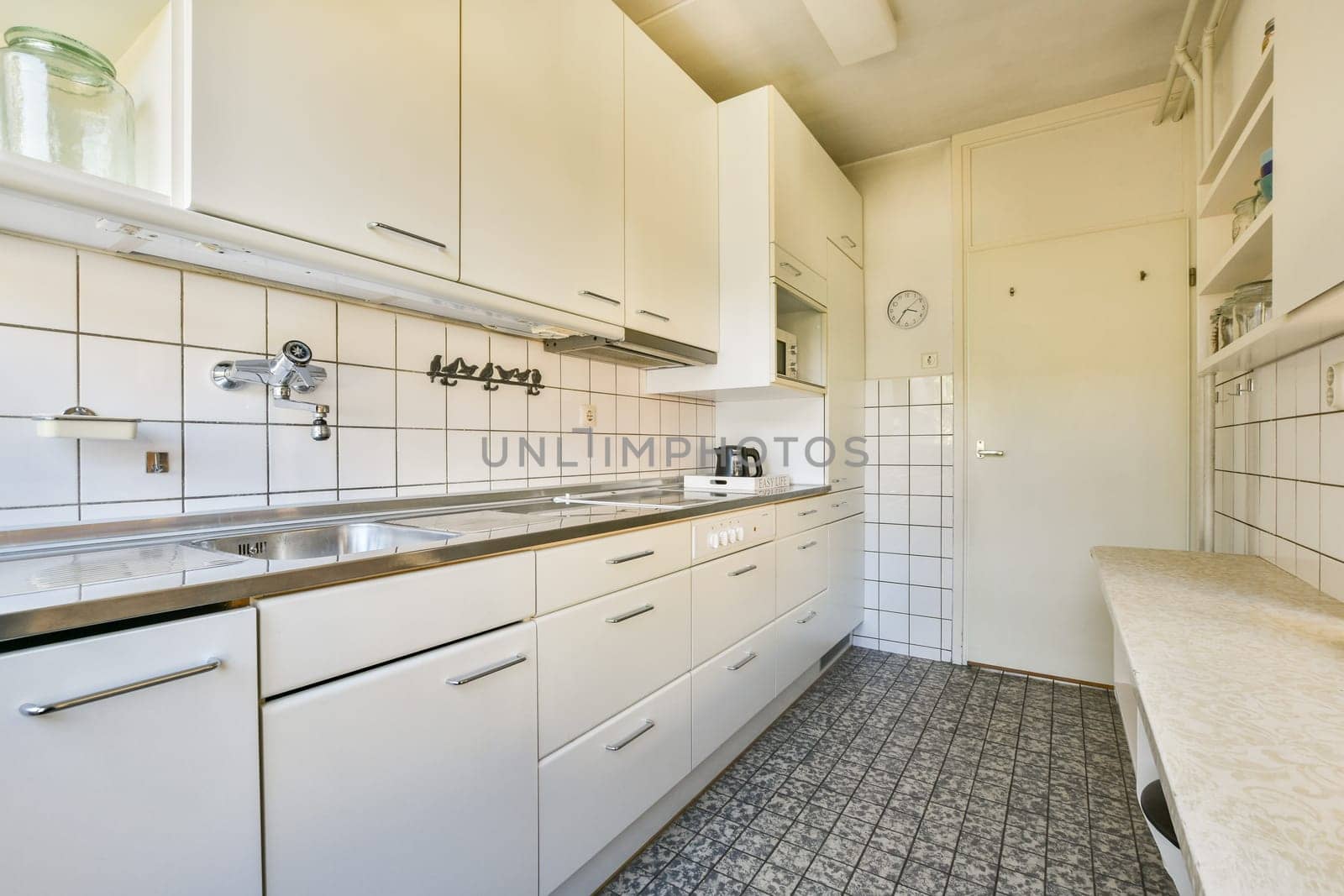 A contemporary kitchen featuring sleek white cabinetry, stainless steel appliances, and minimalist design, showcasing a clean and functional space for cooking.