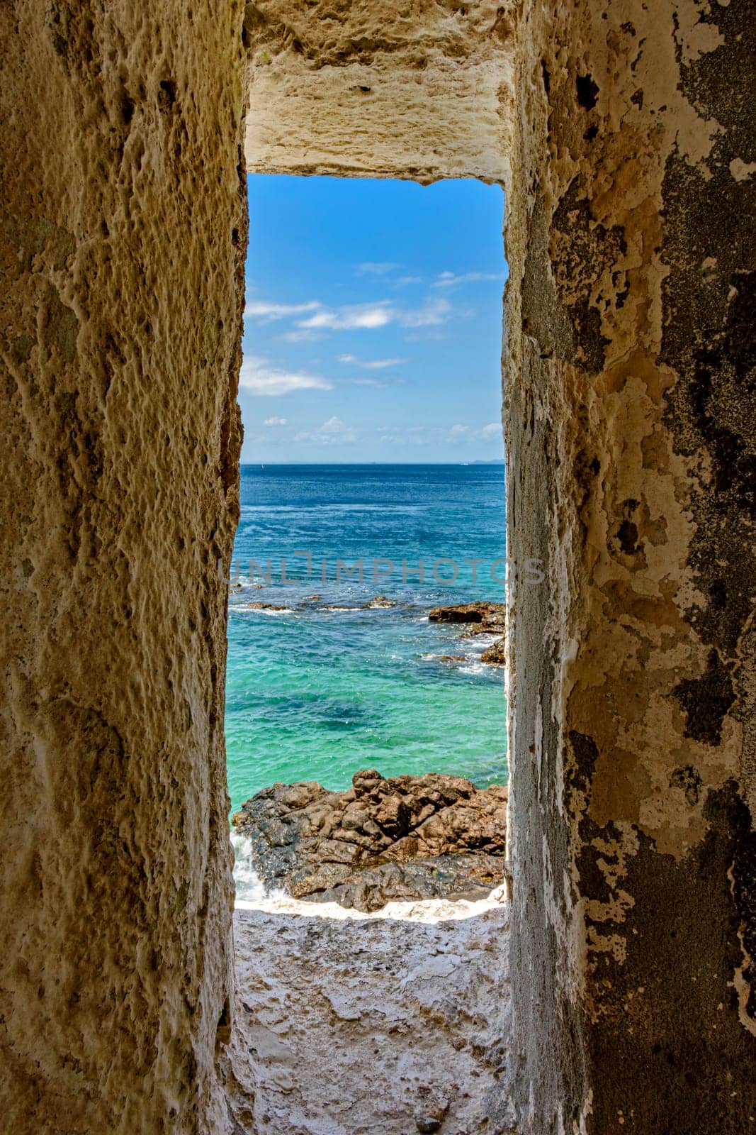 Sea of ​​the city of Salvador in Bahia seen through a small window in a sentry box in the historic fort of Farol da Barra