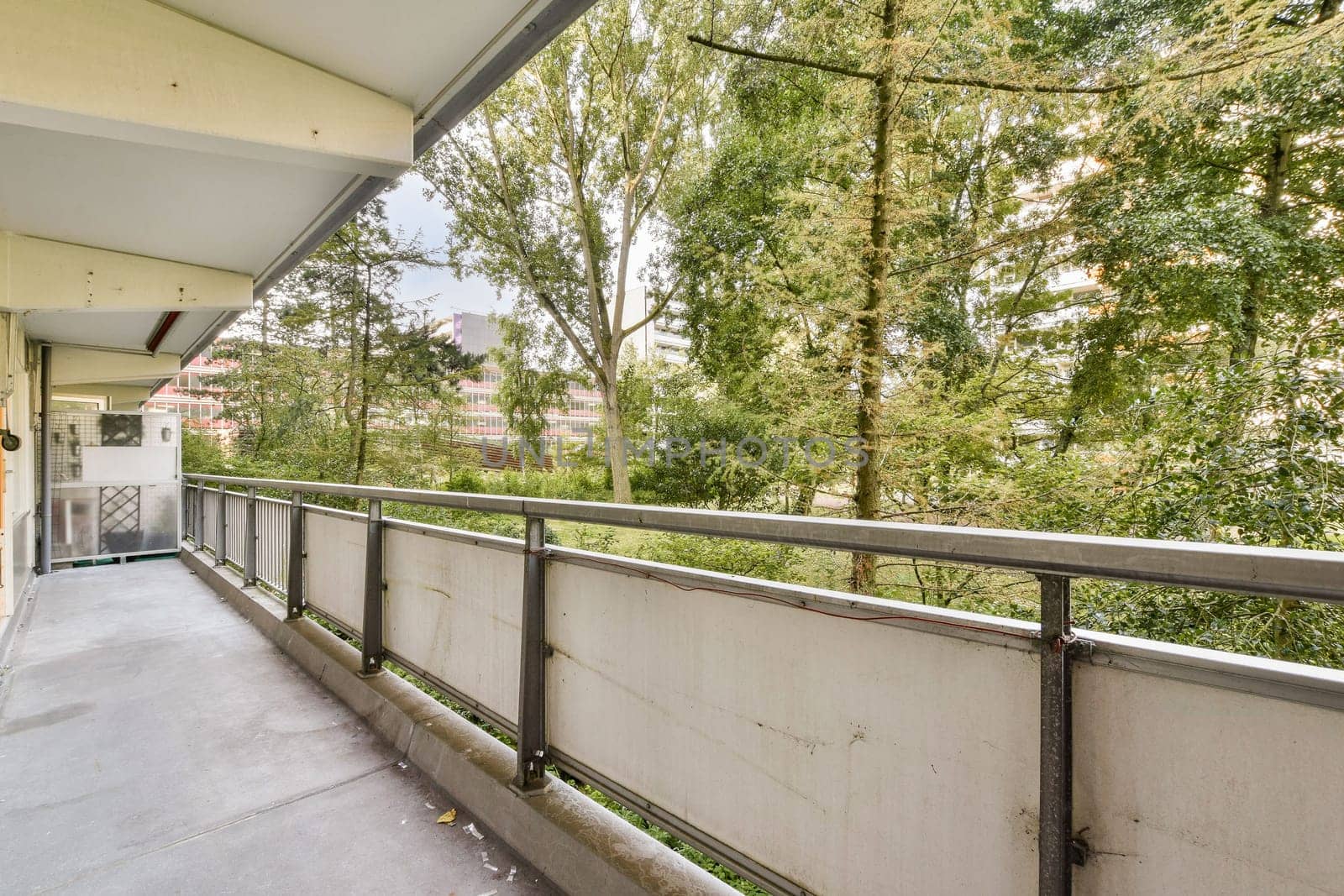A contemporary balcony space showcasing a view of lush greenery, designed for relaxation and outdoor enjoyment. Ideal for urban settings.