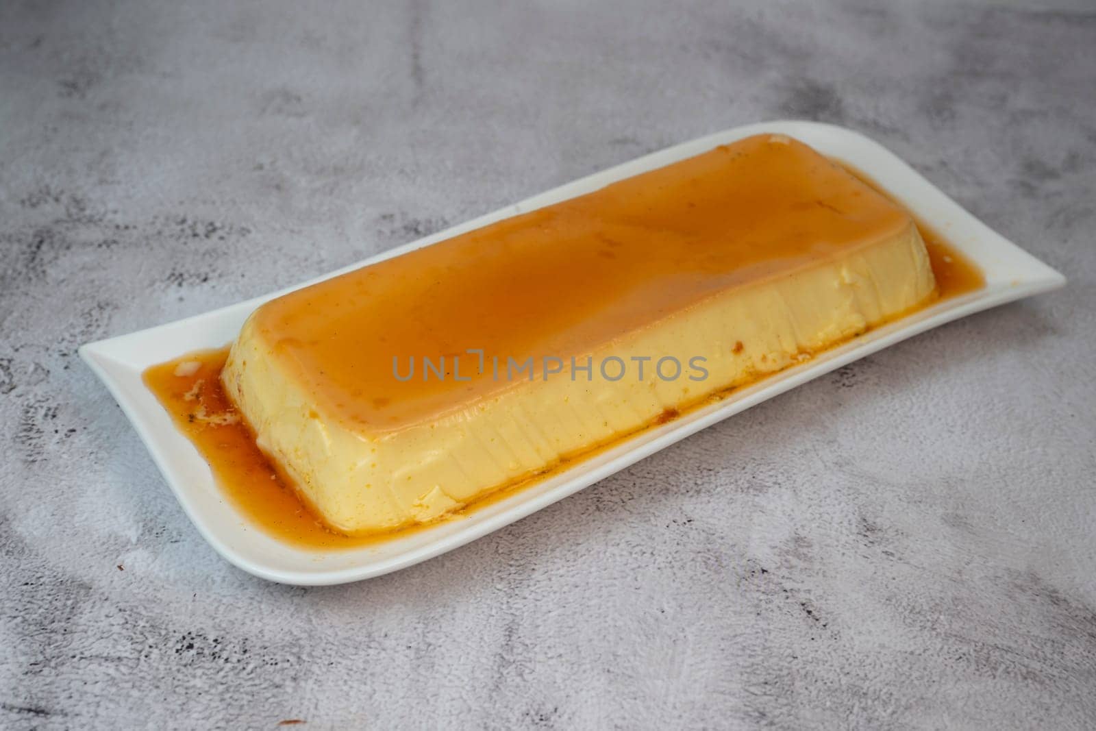 Cream caramel pudding with caramel sauce on a plate, Flan, High quality photo
