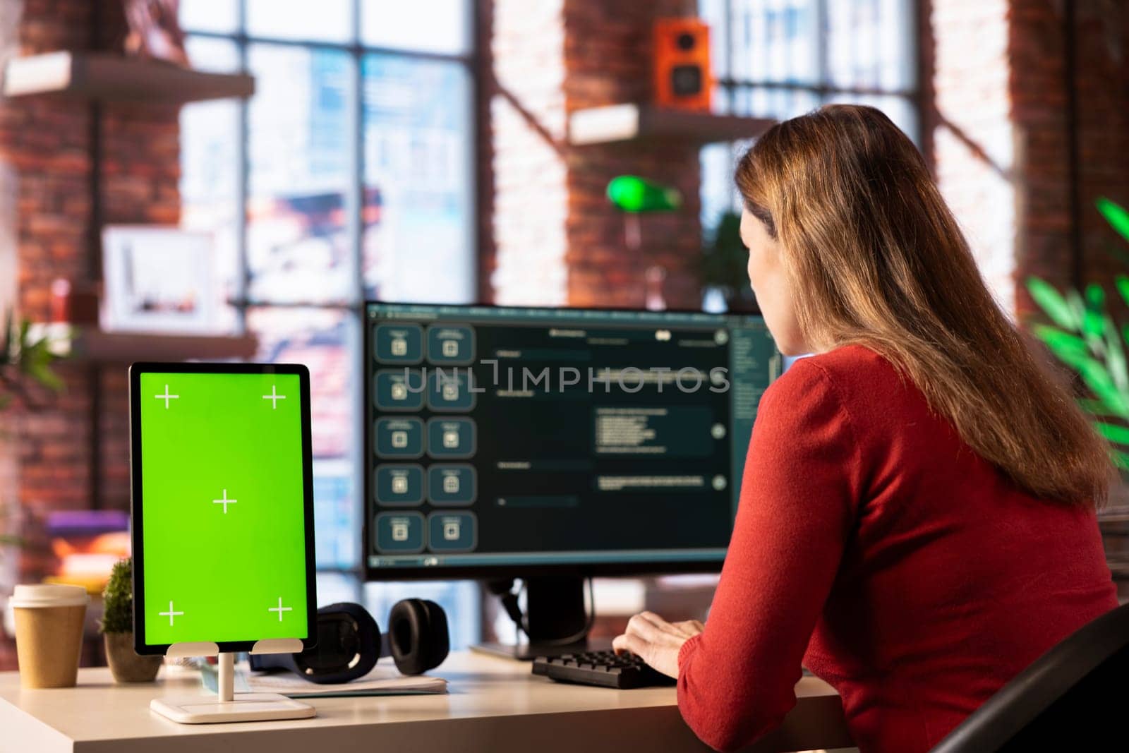 Person utilizes a digital AI tool on web interface next to green screen, doing remote work. Artificial intelligence powered interface simplifies communication and increases efficiency.
