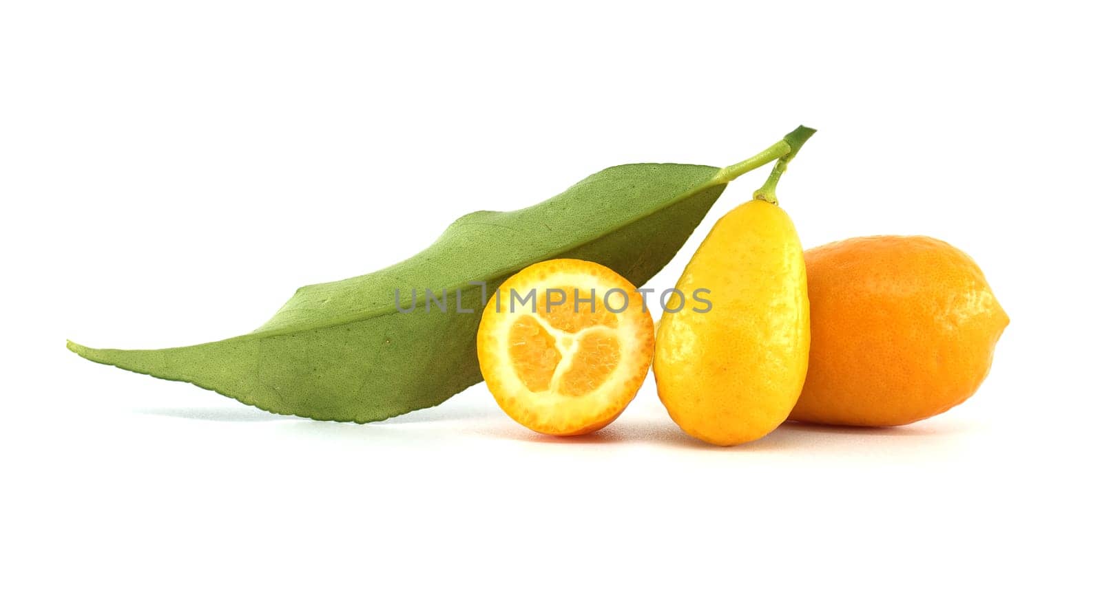 Two fresh kumquats resting on a white background, featuring one whole fruit with vibrant orange skin and a green leaf, alongside a half kumquat revealing its juicy pulp