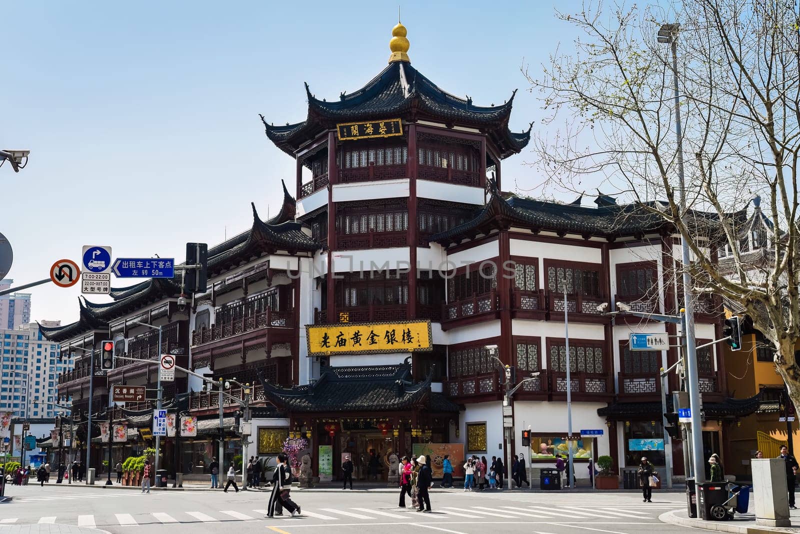 Shanghai, China – 1 April 2025: Traditional architecture and tourists on Yuyuan Old Street, a historic shopping area near Yu Garden in Shanghai Old City