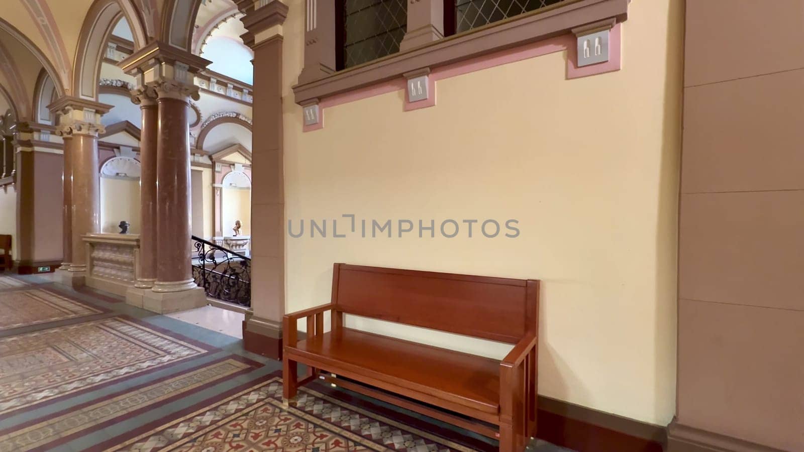 The design showcases stunning architecture with a beautifully crafted wooden bench in a charming historic building