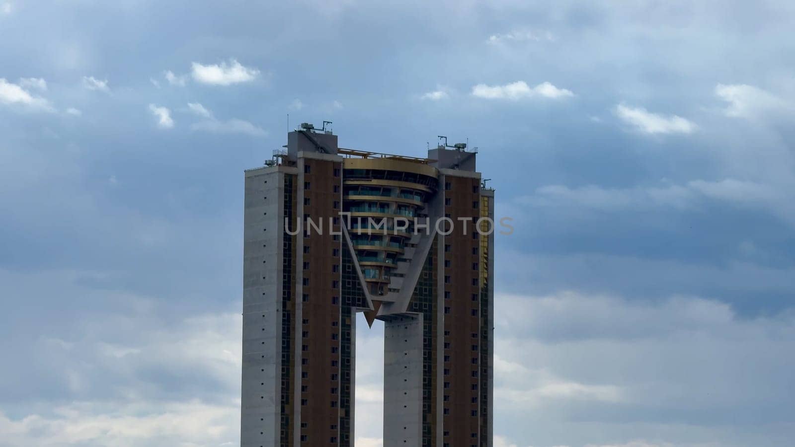 Behold a breathtaking view of an innovative skyscraper that beautifully showcases modern architectural design and style