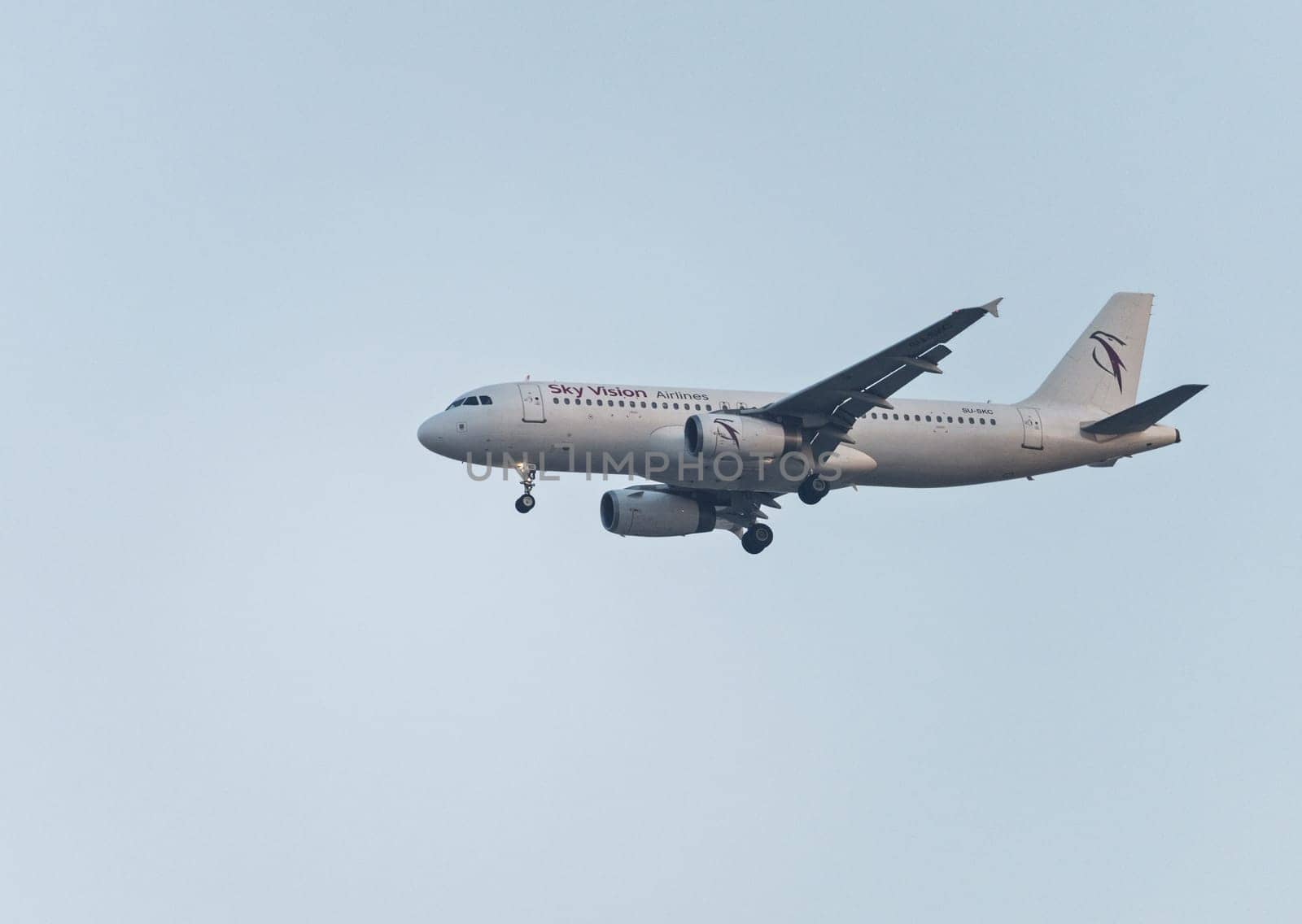 Cairo, Egypt - 7 November 2024: Sky Vision Airbus A320-232 jet plane with landing gear descending to land