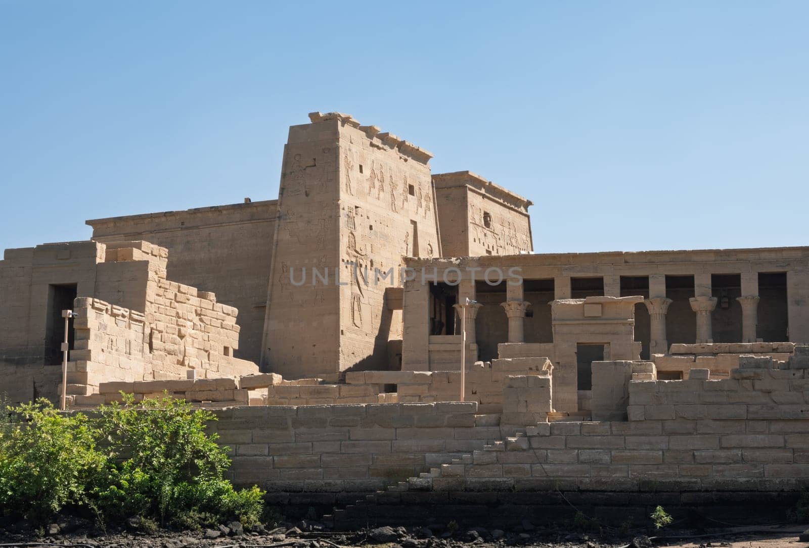 Side view of the reconstructed Philae Temple on an island in Aswan Harbor or Reservoir formed by the Low Dam on the Nile