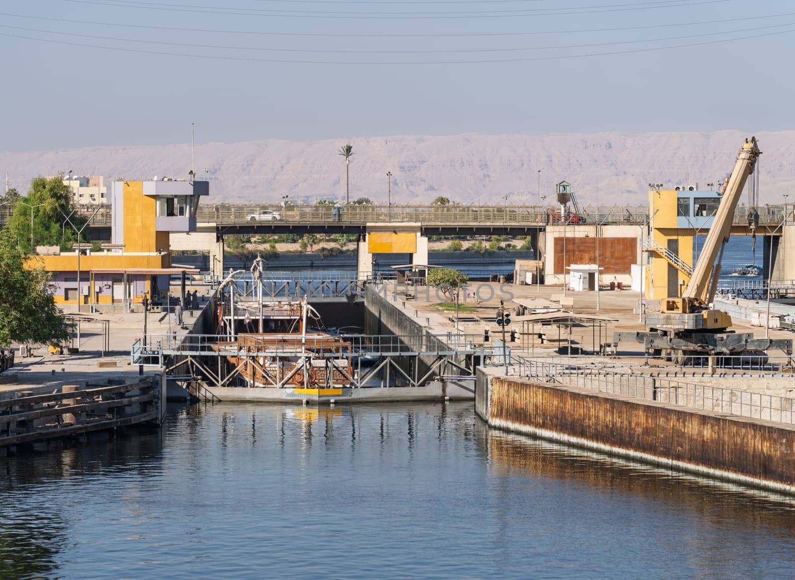 Approaching the new Esna dam and lock on Nile River with dahabiya going through the lock