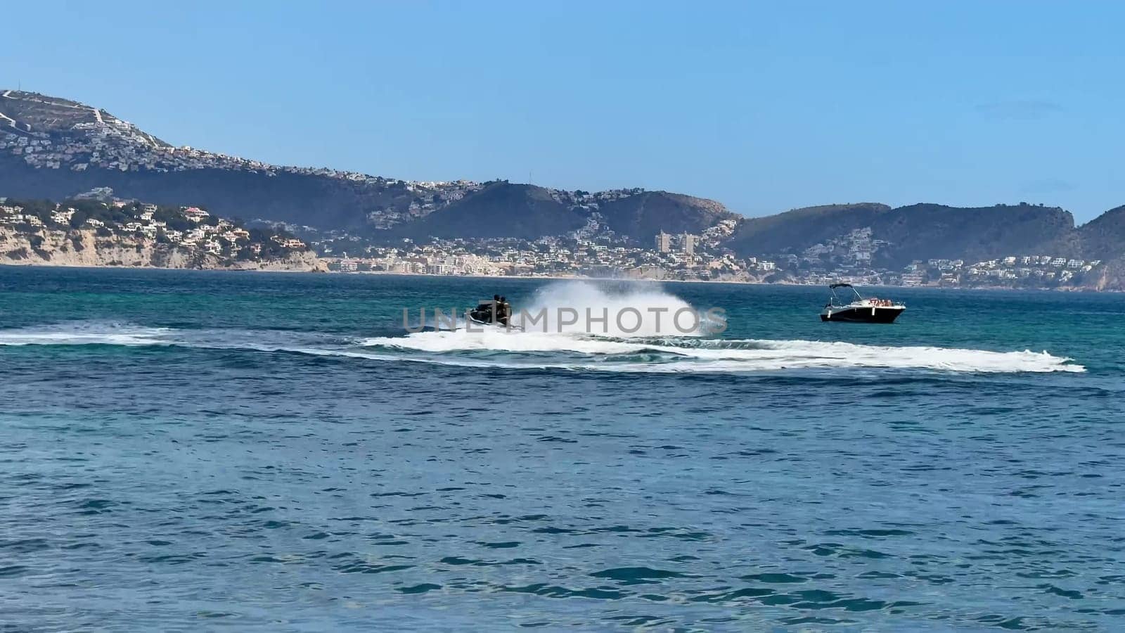 Experience thrilling moments of jet skiing amidst breathtaking and stunning coastal scenery in the sunshine