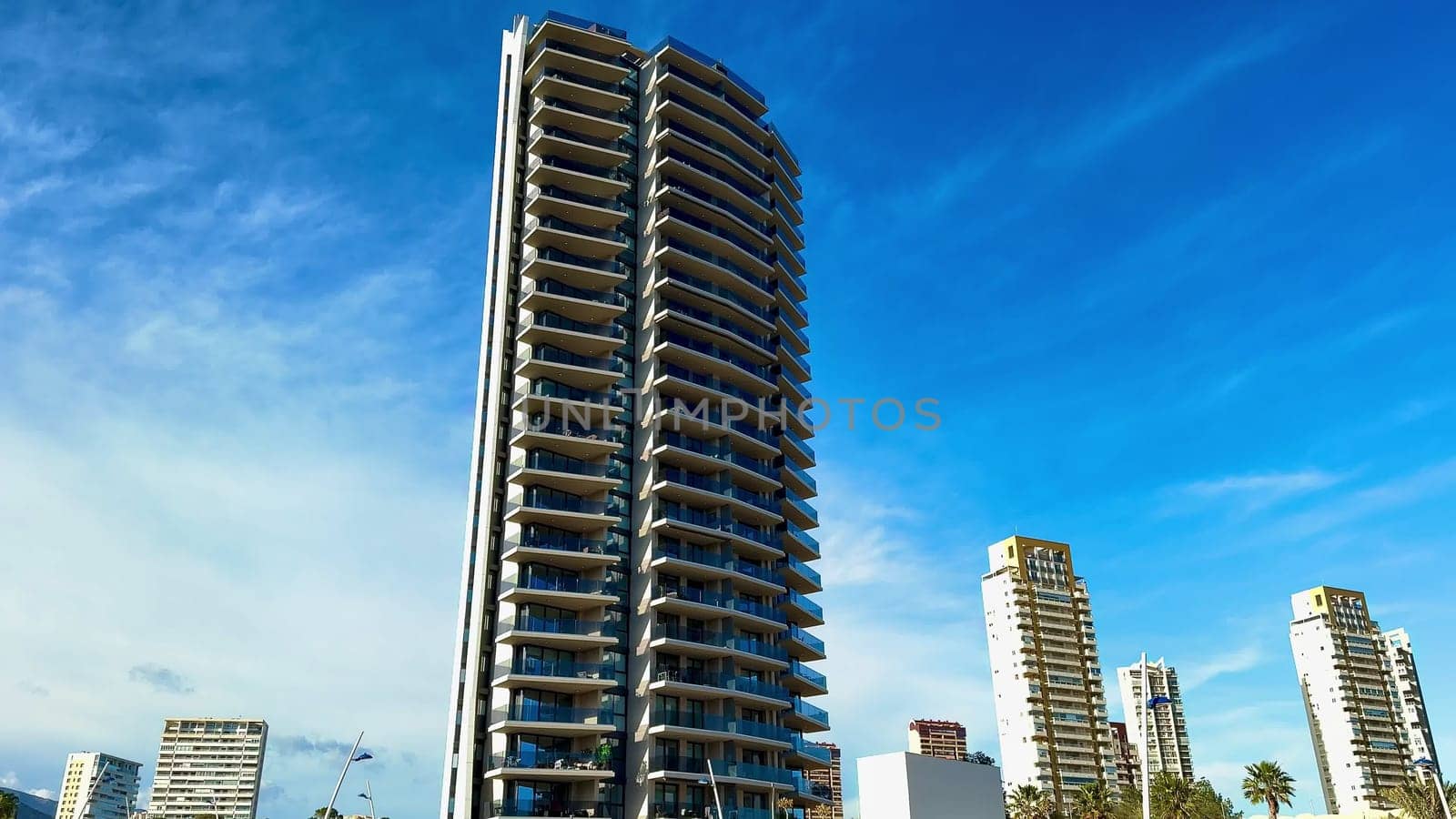 Elegant highrises majestically stand against a stunningly beautiful sky in a vibrant and bustling urban setting