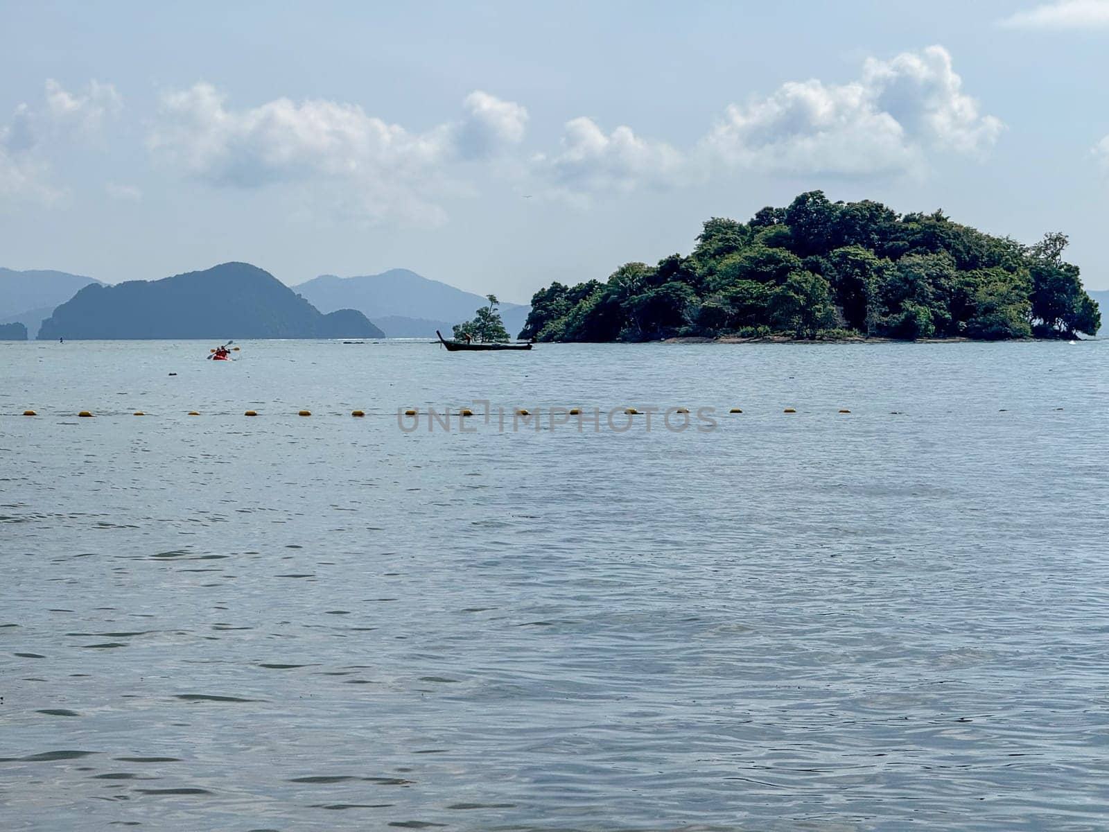 Secluded beach top with tropical scenery and a hidden paradise, showcasing pristine sandy beaches, palm trees and small islands on the stunning ocean waters. Exotic Thai panorama.