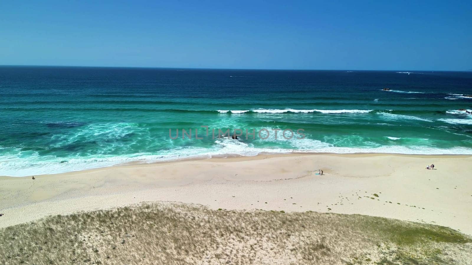A beautifully breathtaking beach scene featuring gentle waves and soft, inviting sand, ideal for relaxation and escape