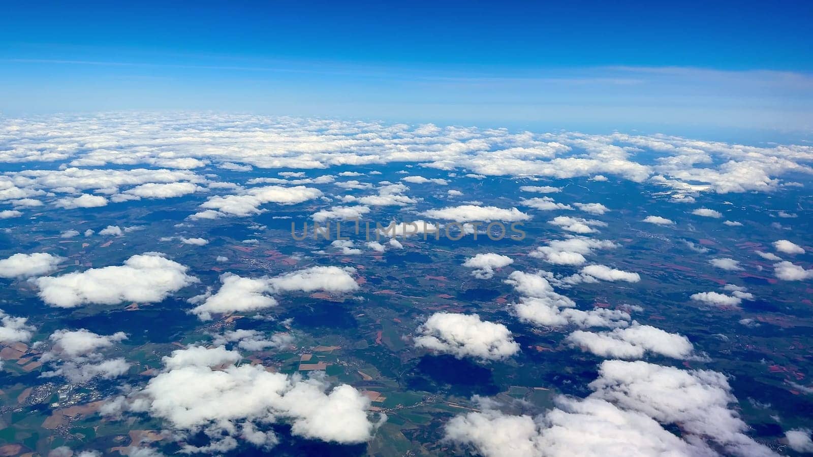Stunning aerial footage beautifully showcasing vivid clouds and vibrant lush green fields captured from above