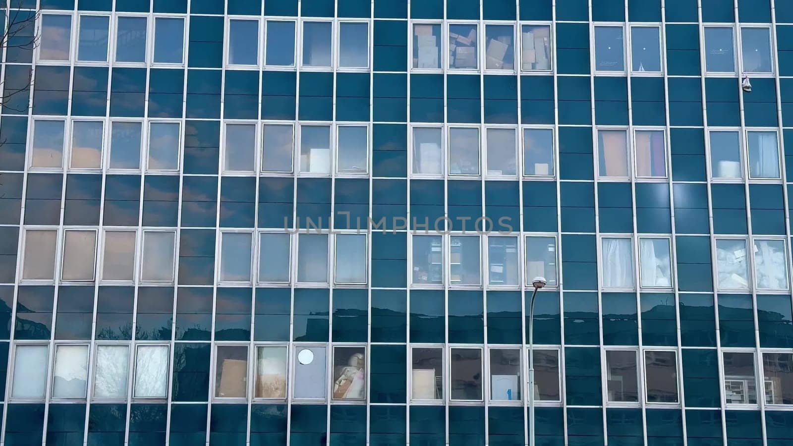 This contemporary office building boasts a striking glass facade that perfectly captures stunning reflections