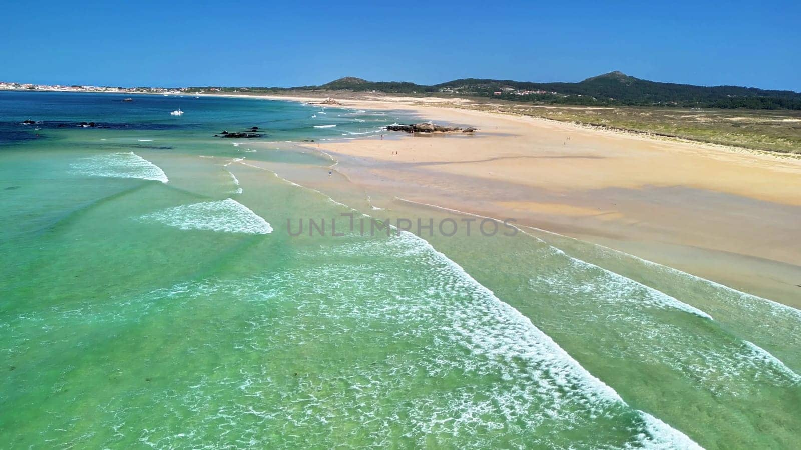Experience the beauty of a tranquil beach with clear waters and golden sands, perfect for relaxation.