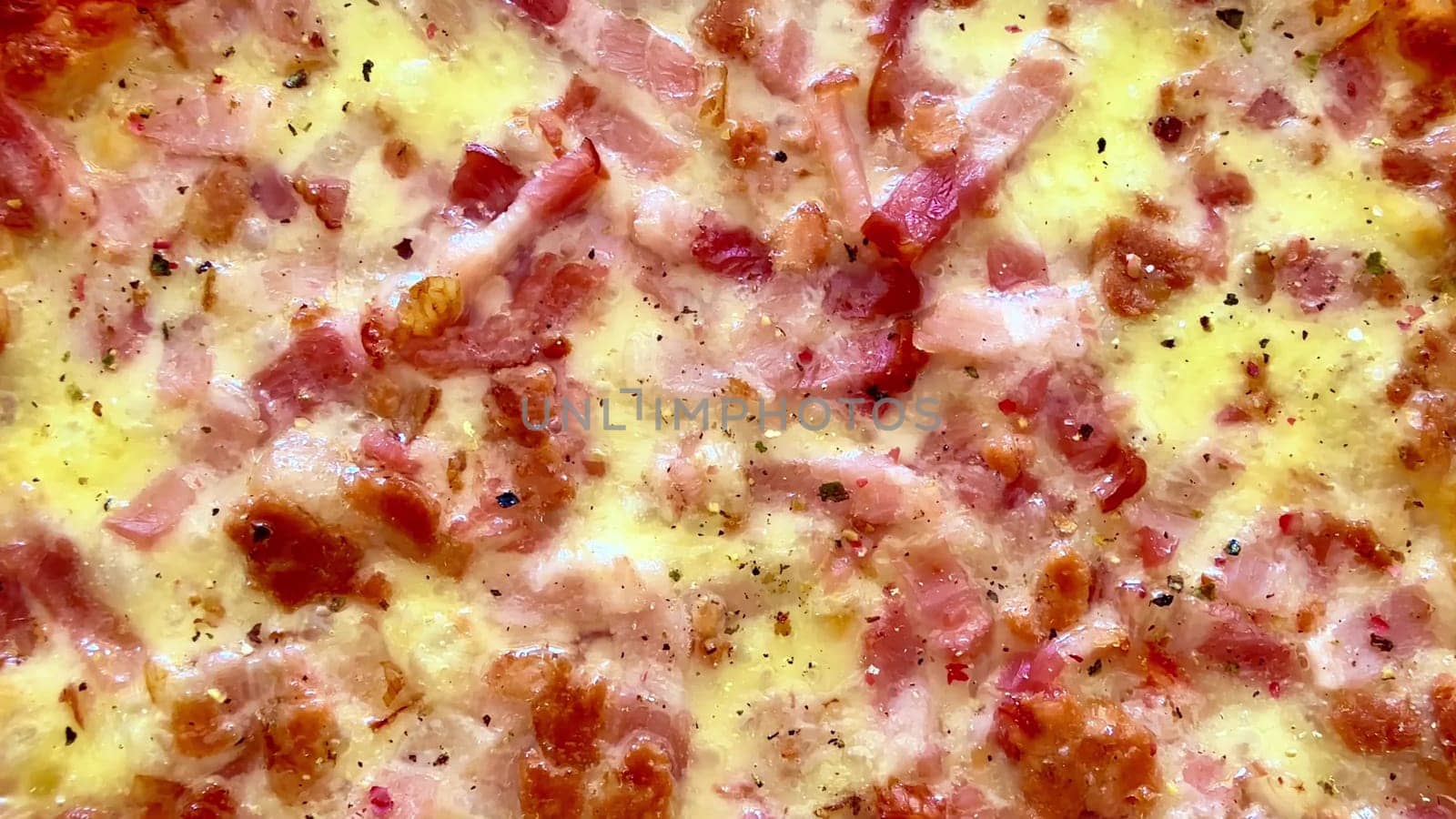 Experience the mouthwatering closeup of a deliciously tasty bacon and cheese pizza, so fresh from the oven