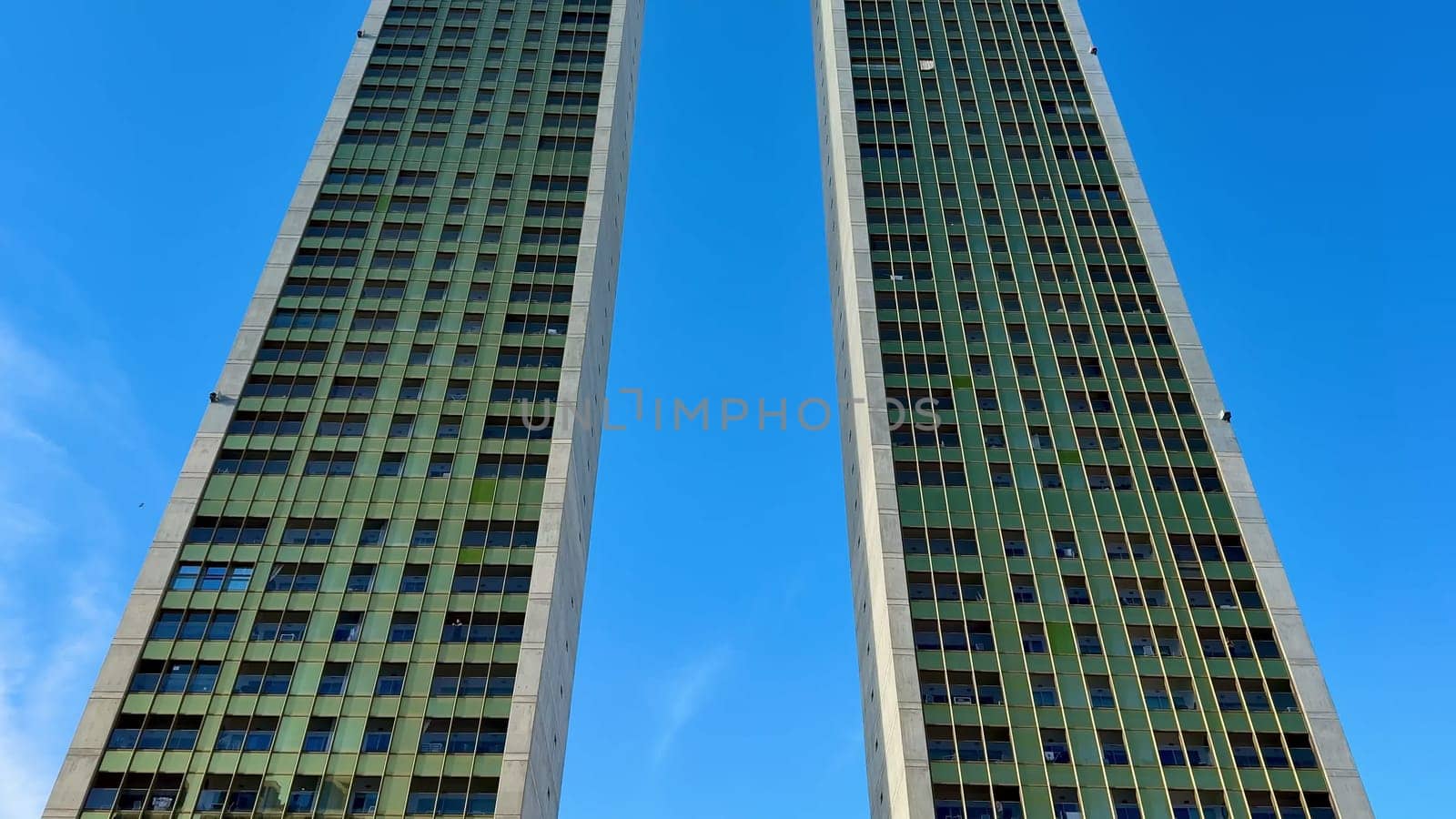 A stunning view featuring two impressive modern twin towers beautifully set against a bright blue sky