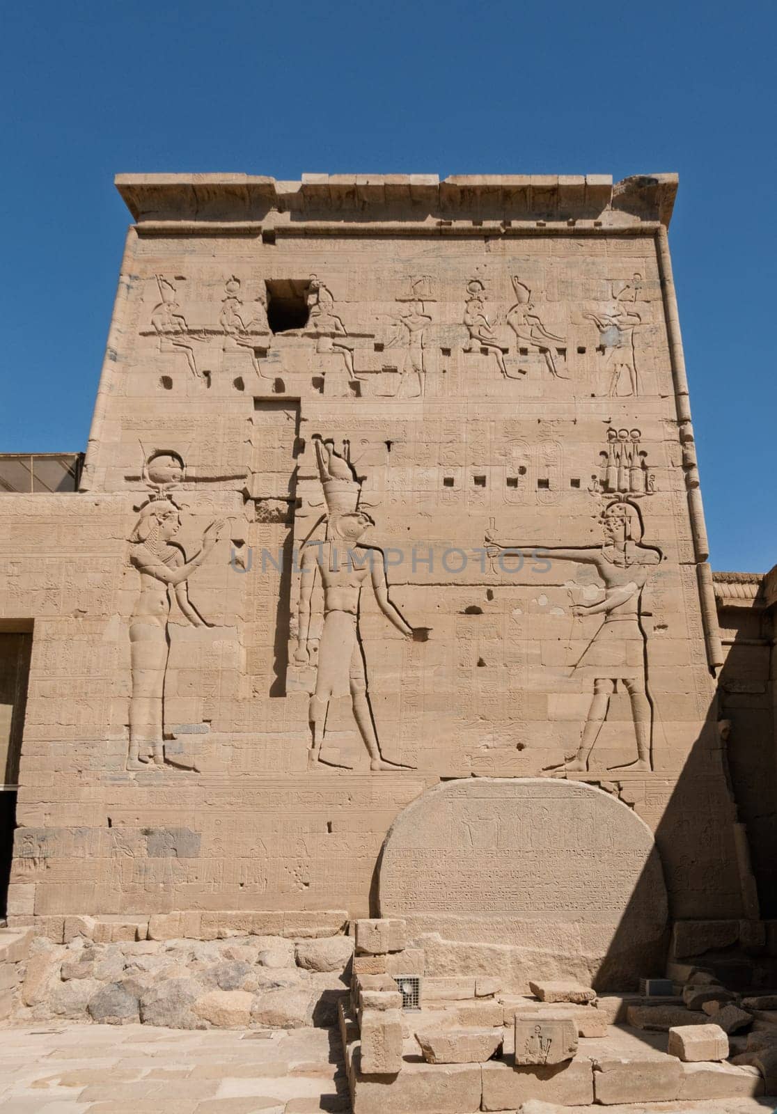 Detail of the bas-relief carving of the Isis and Horus facing Pharoah in the reconstructed Philae Temple in Aswan Harbor in Egypt