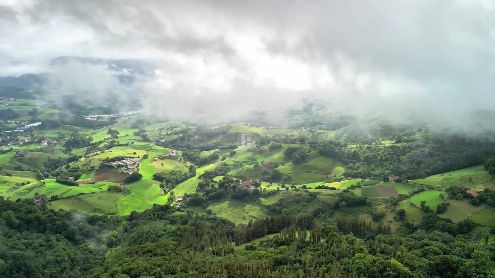 A stunning aerial view showcases vibrant greenery and cloudy skies, perfect for exploring and appreciating nature