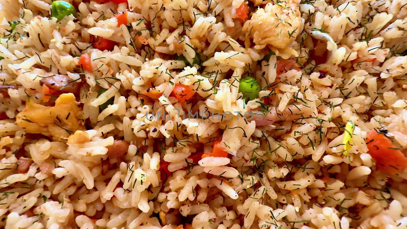 A vibrant and colorful plate of fried rice, filled with fresh vegetables and aromatic herbs to truly delight the senses