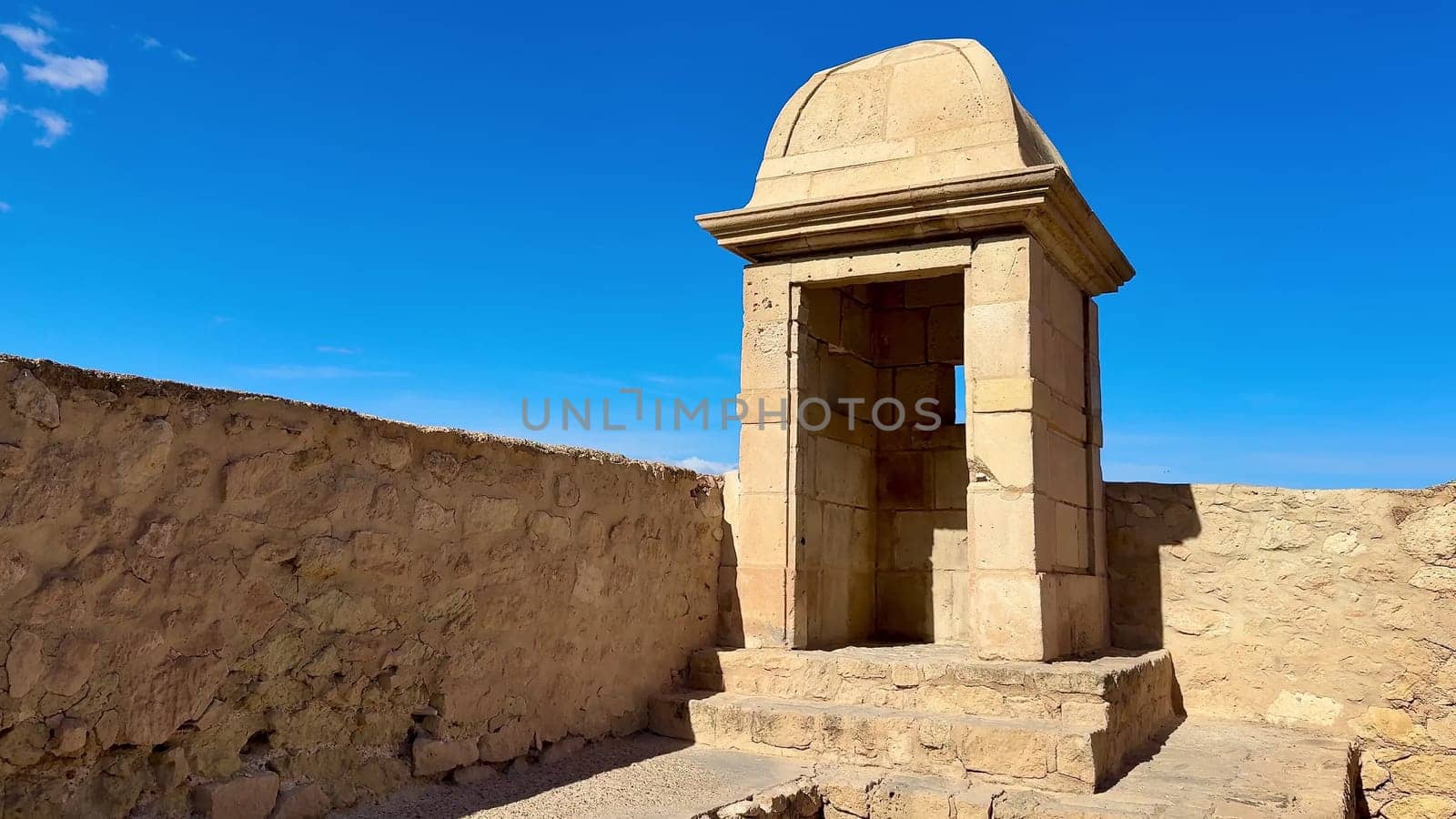 A stunning ancient stone structure against blue skies, showcasing impressive historical architecture