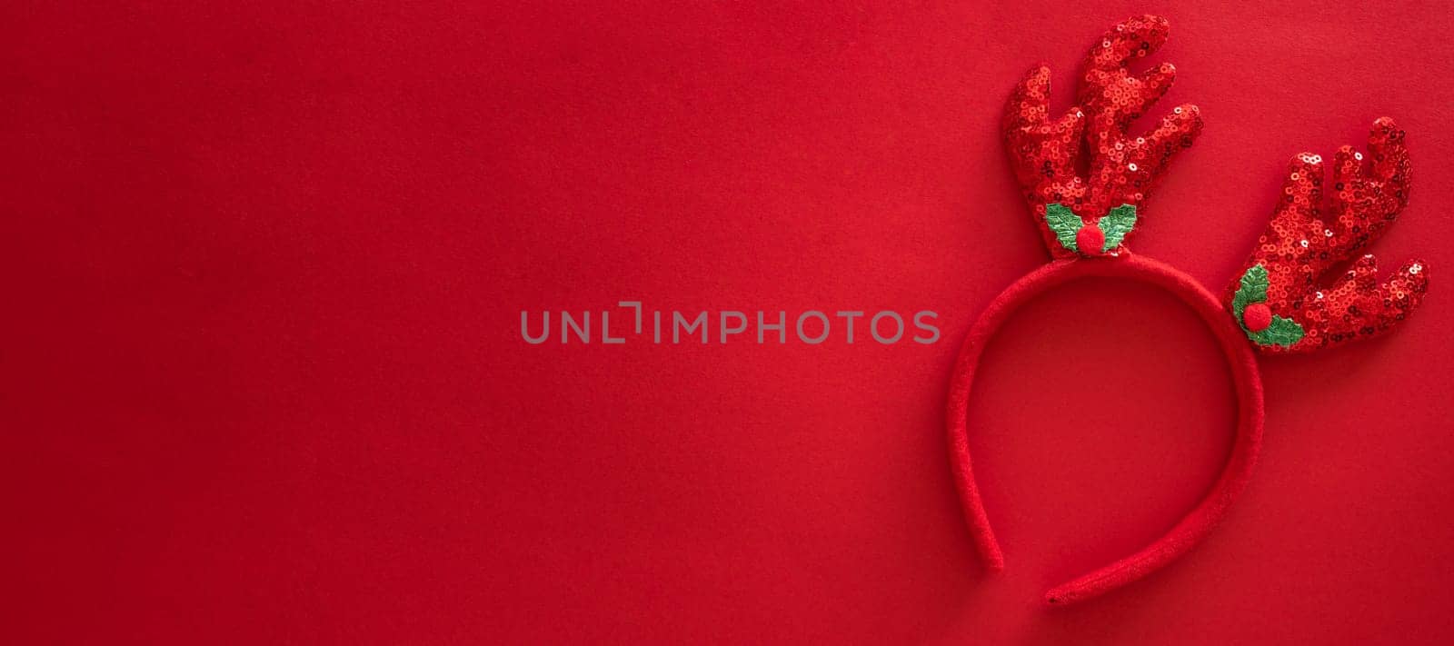 Colorful reindeer antlers headband. Holiday costume detail. Creeting card. Horn of a Christmas deer. New Year decoration on hair. Top view, flat lay, banner
