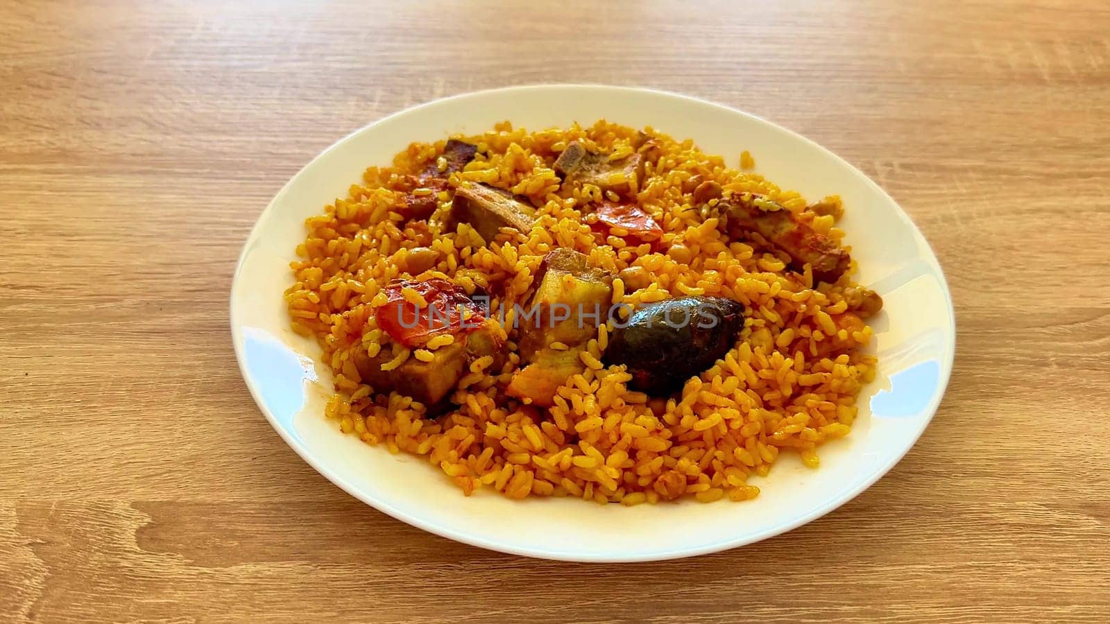 A delightful and vibrant plate of Jollof rice, beautifully featuring tender chicken and an array of fresh vegetables