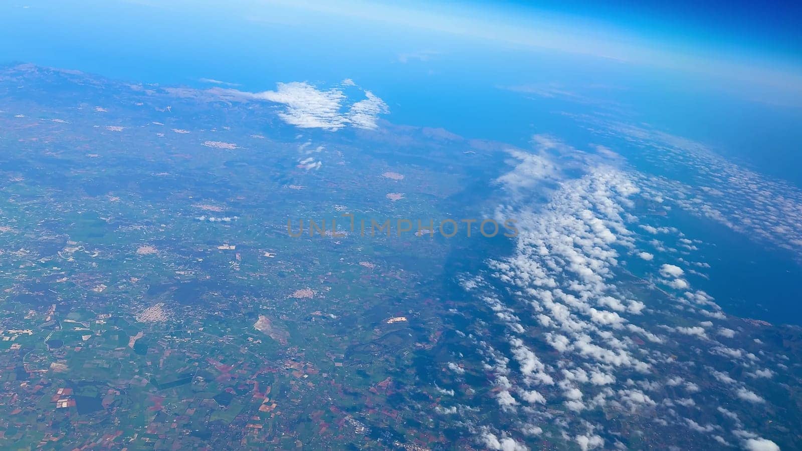 A breathtaking and captivating perspective of Earth showcasing both clouds and land from a notably high altitude