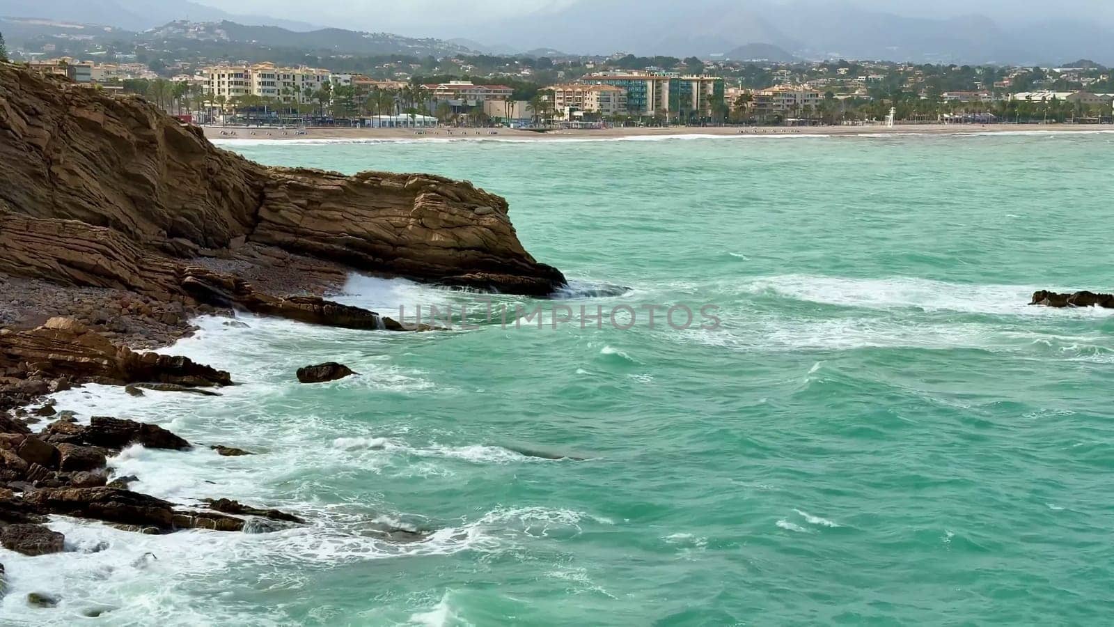 A breathtaking coastal scene showcasing vibrant turquoise waters along with a stunning city skyline visible