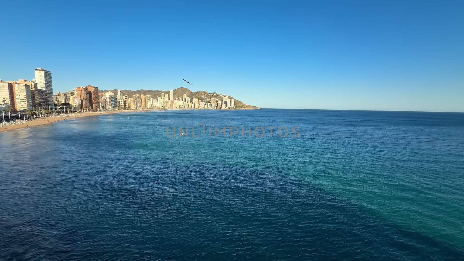 Enjoy a breathtaking and stunning view of Benidorms beautiful coastline and the calm sea on a clear day