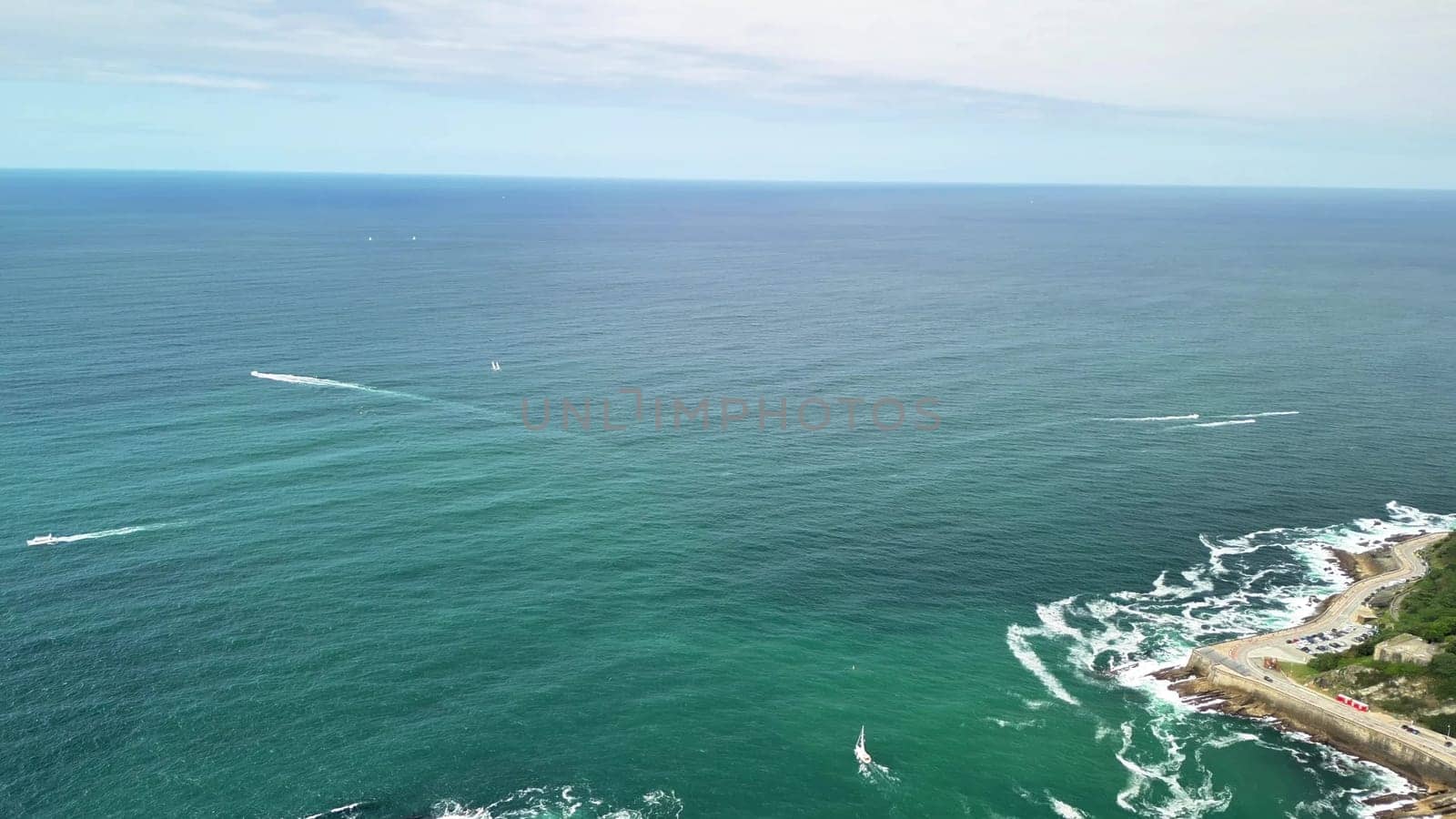 This breathtaking aerial view beautifully showcases an enchanting coastline, an island, and a vibrant cityscape