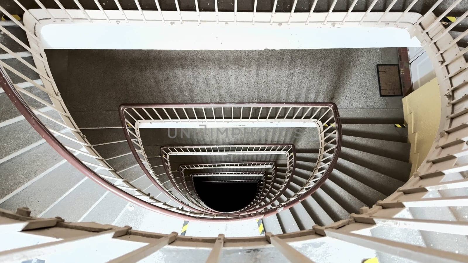 A stunning overhead view of a spiral staircase, highlighting its elegant curves and intricate design details