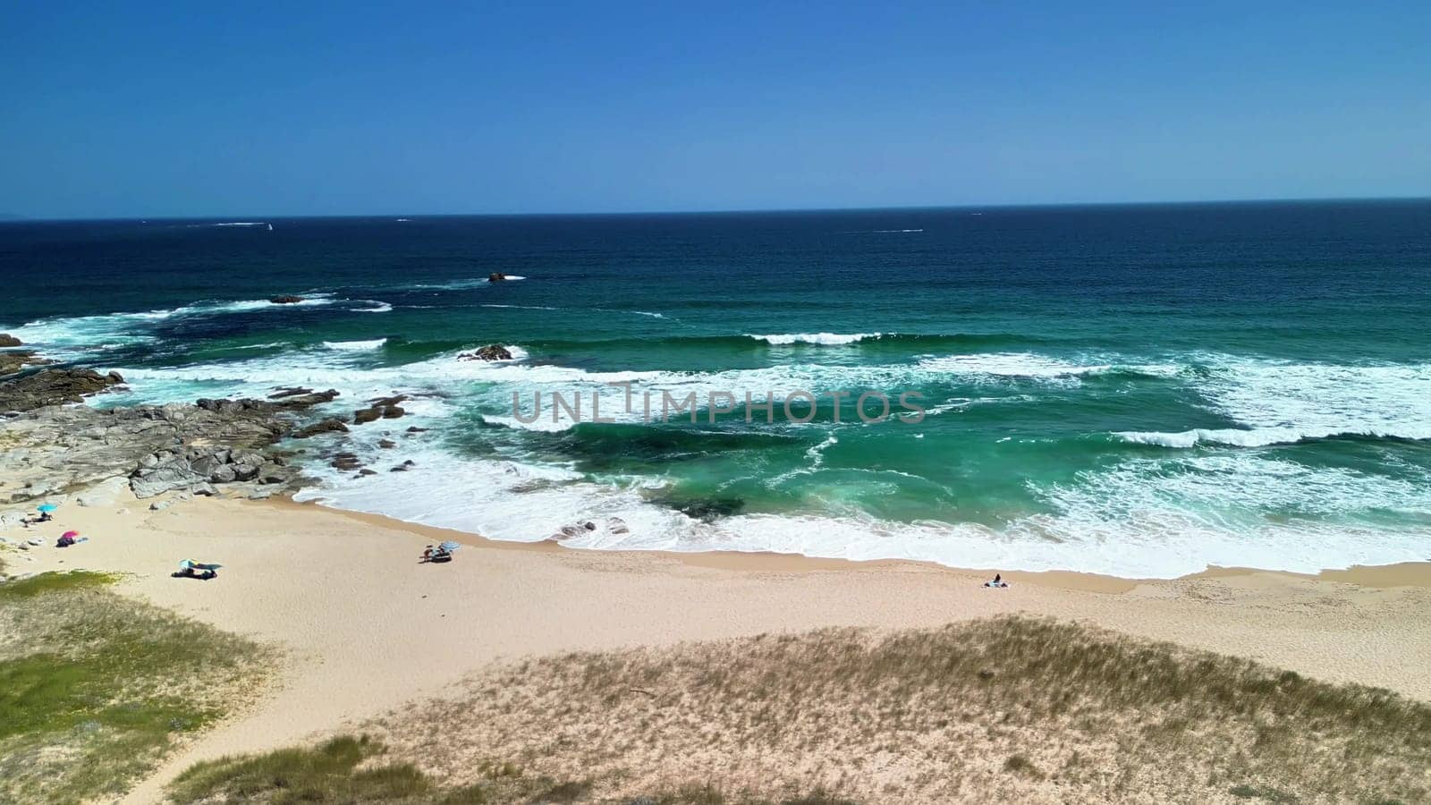 Breathtaking aerial shots capture a vibrant beach, showcasing stunning turquoise waves and soft golden sands