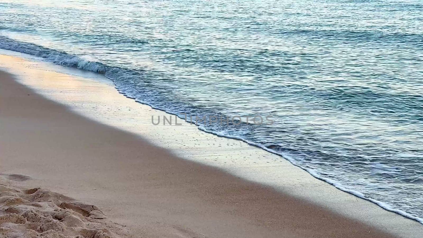 A serene and tranquil scene of gentle waves softly lapping at a beautiful sandy beach, perfect for ultimate relaxation