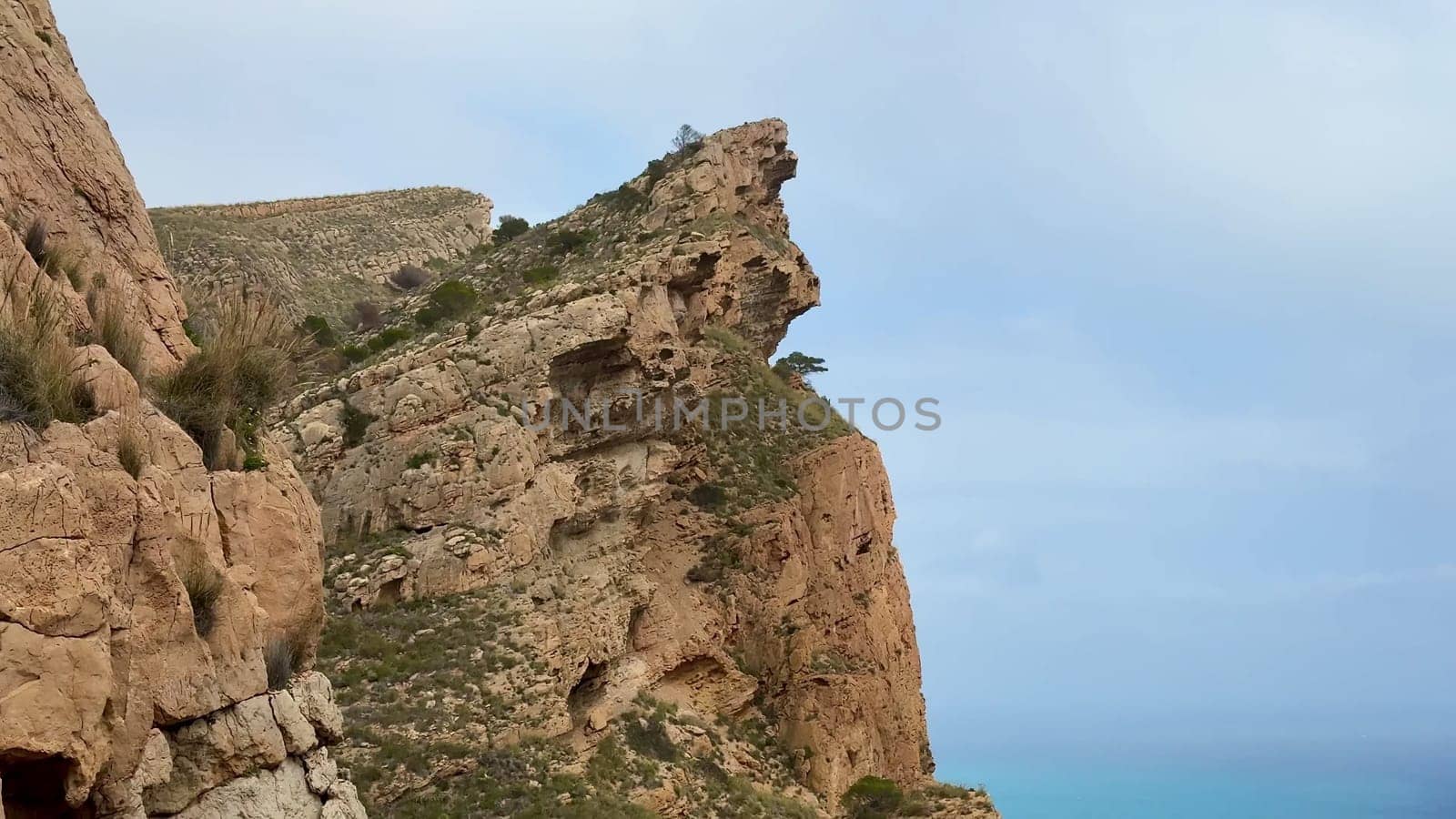 The breathtaking cliffs, adorned with lush greenery, provide stunning views of the vibrant blue ocean below