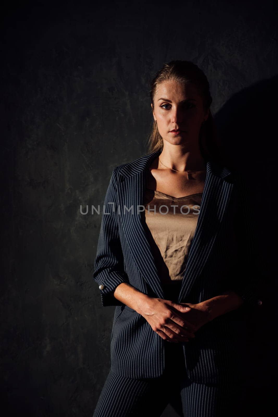 Portrait of a beautiful fashionable woman in a gray business suit