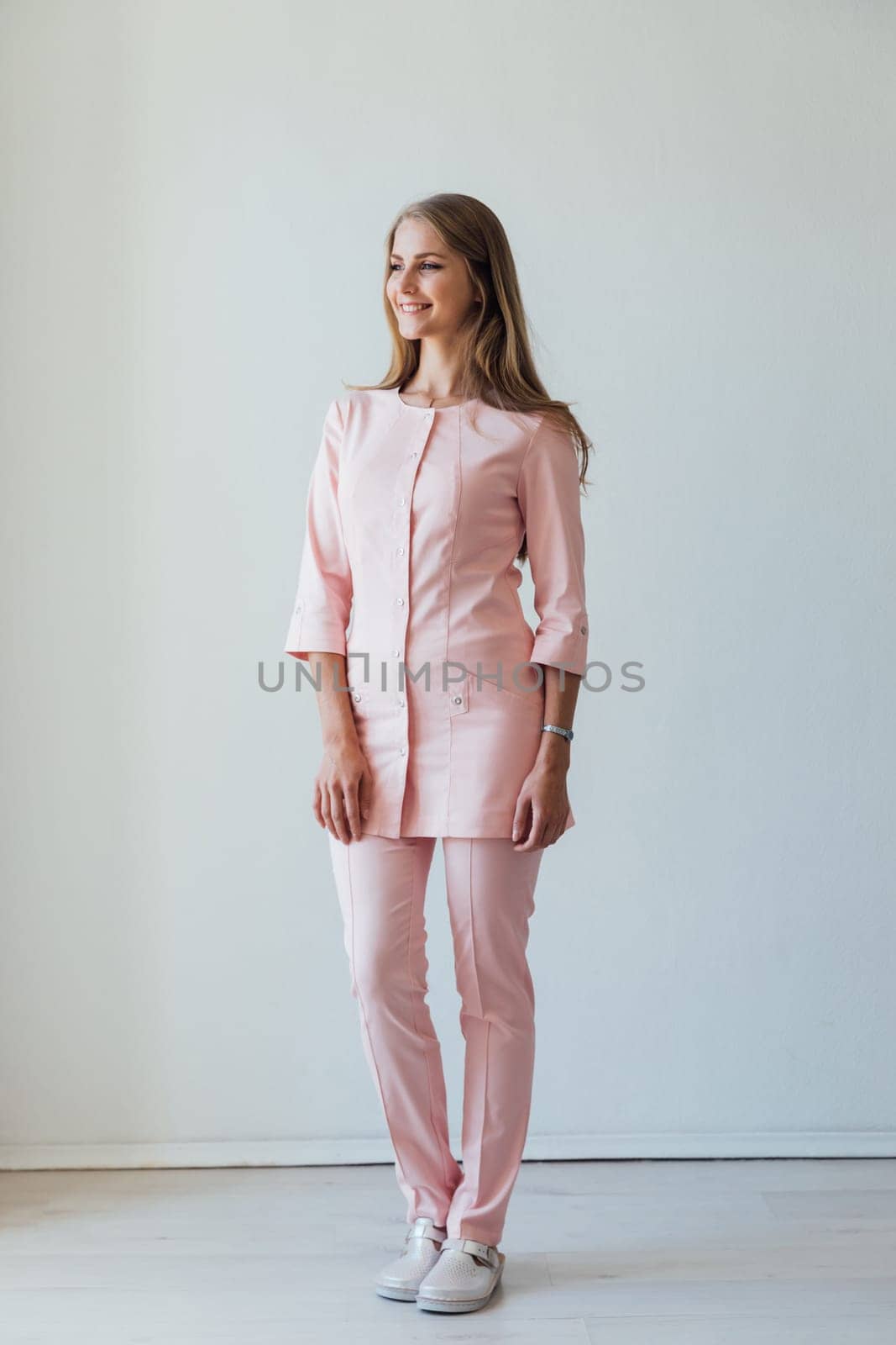Woman doctor with smiling on white hospital background