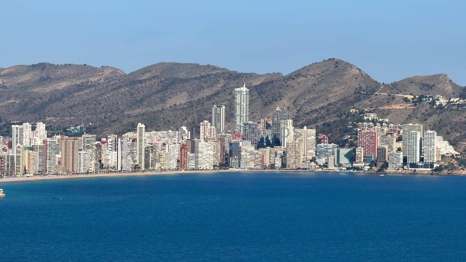 Experience the breathtaking skyline of Benidorm and its stunning coastline, framed by majestic mountains