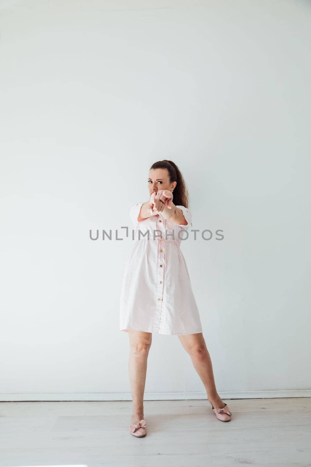 Brunette 40 years old in summer dress dancing to music
